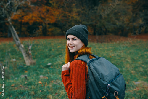 woman with backpack on her back hiking travel hat sweater model