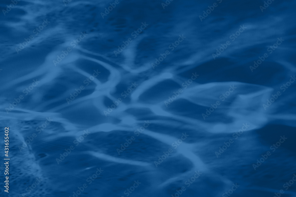 Fototapeta premium Trendy blue colored low contrast abstract background with light and shadows caustic effect. Light passes through a glass. Water background. 
