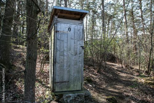 The rural wooden dry toilet standing in the wood by the cottages area. 