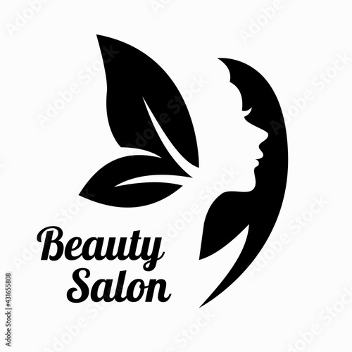 Black silhouette of a woman with foliage. Beauty salon logo