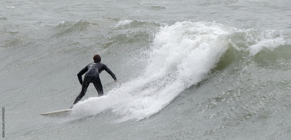 a surfer surf a wave in italy