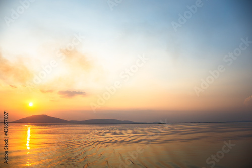 Beautiful landscape sunset with mountain lake  reflection  golden sky and yellow sunlight in sunrise. Thailand. Amazing scene.