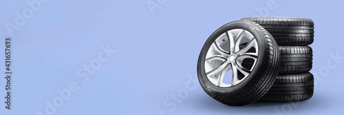 summer tires and wheels-stack on blue background, new wheels long blank layout copyspace
