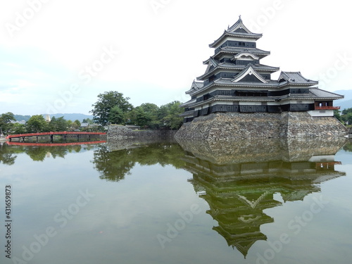          matsumoto castle with reflection on the water