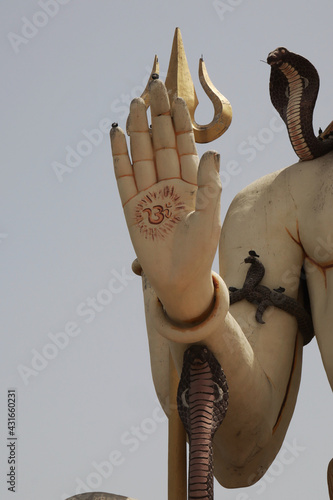 Vertical shot of the hand of the statue of Buddha in Nageshwar Shiva Temple Goriyali in India photo