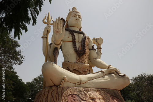 Low angle shot of the statue of Buddha in Nageshwar Shiva Temple Goriyali in India photo