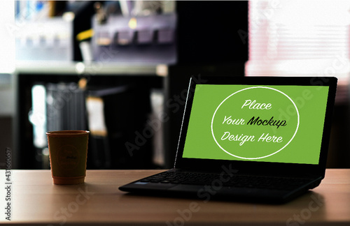 Cropped shot of Mock up PSD Laptop blank screen with take away coffee on the table in office.