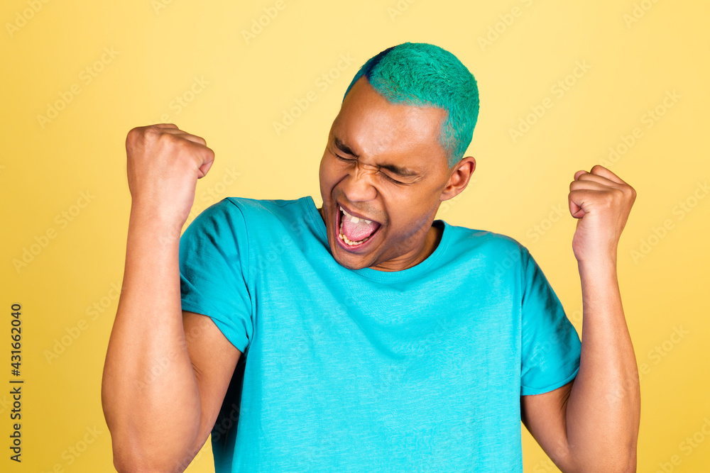 Black african man in casual on yellow background happy excited clenching fist, winner gesture Black african man in casual on yellow background happy excited clenching fist, winner gesture