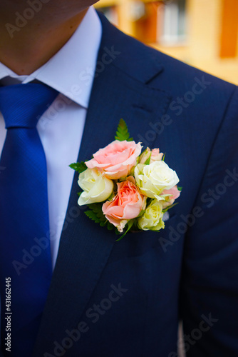 groom with flowers boutonniere