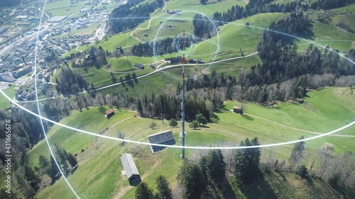 Communication mast on hill sends 5G network signals to village in the valley