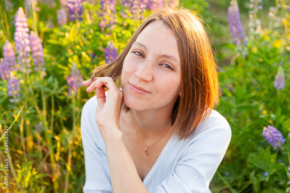 Happy girl smiling outdoor. Beautiful young brunete woman resting on summer field with blooming wild flowers green background. Free happy european woman. Positive human emotion facial expression. Happy girl smiling outdoor. Beautiful young brunete woman resting on summer field with blooming wild flowers green background. Free happy european woman. Positive human emotion facial expression.