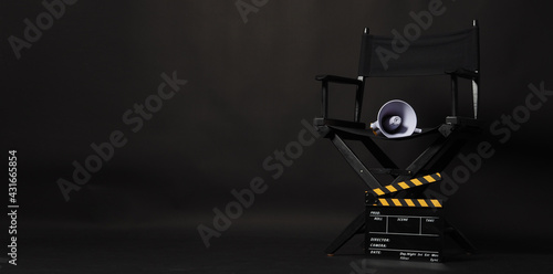 Black director chair and Clapper board or movie Clapperboard with yellow megaphone on black background.use in video production or film cinema industry