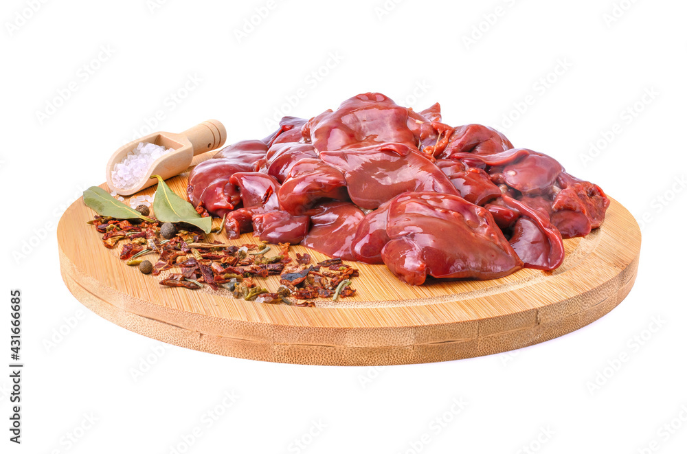 raw chicken liver with spices on a round wooden cutting board close-up isolated on a white background