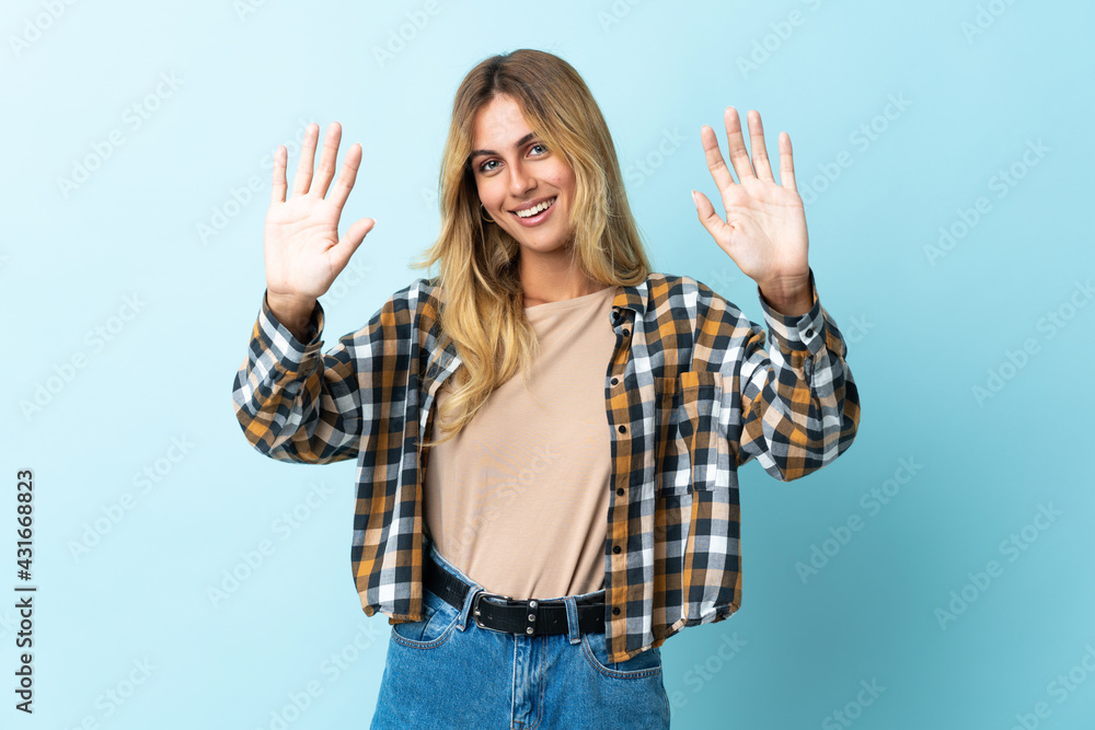 Young blonde Uruguayan isolated on blue background counting ten with fingers Young blonde Uruguayan isolated on blue background counting ten with fingers