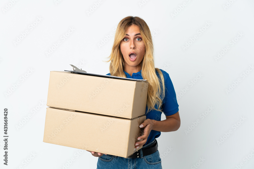 Young blonde Uruguayan delivery woman isolated on white background with surprise facial expression Young blonde Uruguayan delivery woman isolated on white background with surprise facial expression