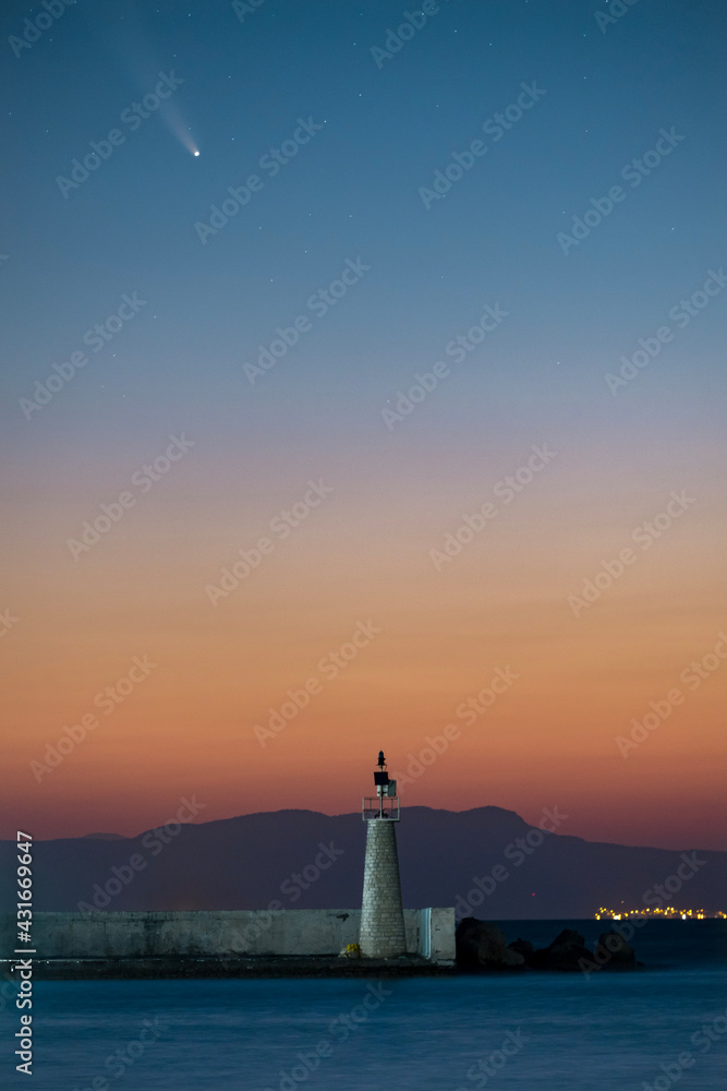 Comet neowise passing over the lighthouse in Kokkari village of Samos