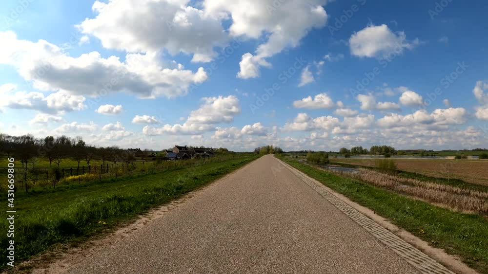 Dutch polder dike road nice clouds spring day POV Dutch polder dike road nice clouds spring day POV