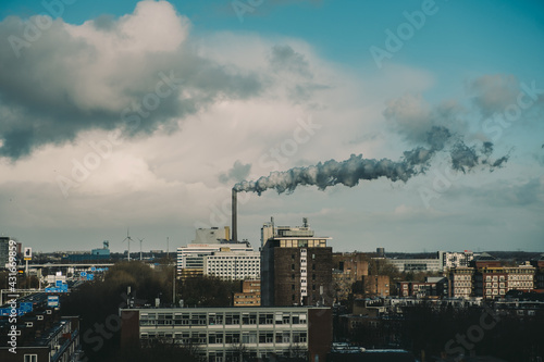 A photo in the center of Amsterdam depicting the pollution by a factory. © Dimitris