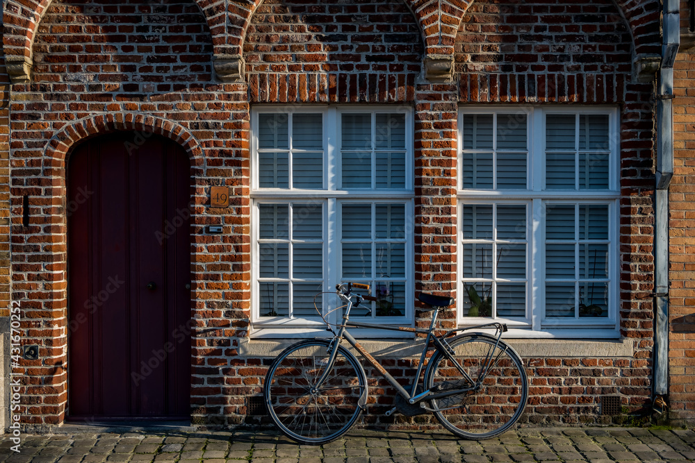 A bicycle in front of a brick wall in Belgium Brugges