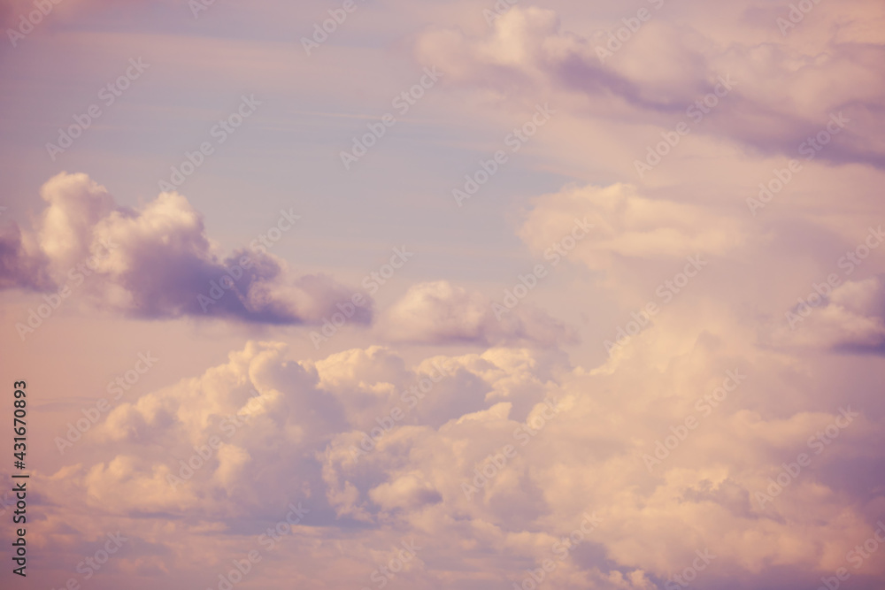 White clouds on a soft pink sky, evening cloudscape White clouds on a soft pink sky, evening cloudscape