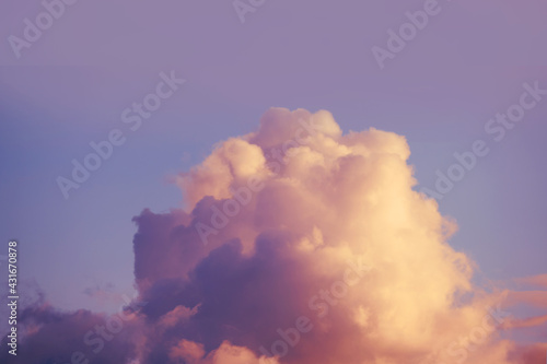 Large fluffy cloud background on soft sunset sky