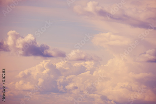 White clouds on a soft pink sky, evening cloudscape