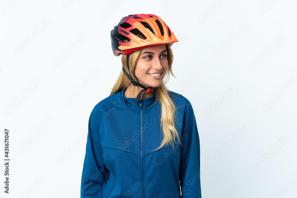 Young blonde Uruguayan cyclist woman isolated on background looking side Young blonde Uruguayan cyclist woman isolated on background looking side