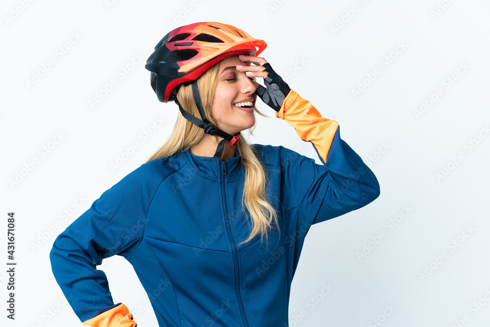 Young blonde Uruguayan cyclist woman isolated on background smiling a lot Young blonde Uruguayan cyclist woman isolated on background smiling a lot