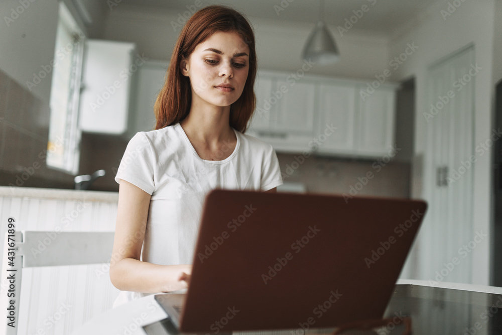 woman with laptop sitting at table freelancer working outside office kitchen interior woman with laptop sitting at table freelancer working outside office kitchen interior