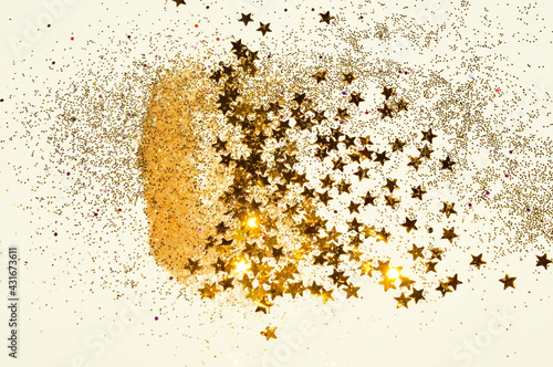 Gold glitter and glittering stars on light gray background in vintage colors © mila_1989
