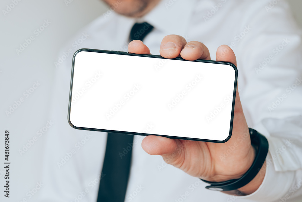 Mobile smart phone blank screen mock up in hand of a businessman Mobile smart phone blank screen mock up in hand of a businessman