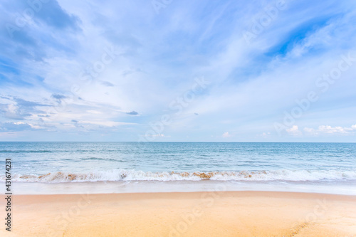 White cloud, blue sky and sea with green land as the sea view in natural background.