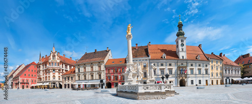 Banner, Maribor city center in Slovenia. Town Hall and Plague Monument on the Maribor Main Square. Blue sky, bright daylight, panoramic cityscape. Famous tourist destination in Europe. photo