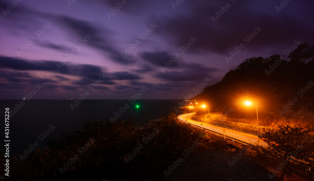 Fototapeta premium Winding road of Chaloem Burapha Chonlathit Road at night view from Noen Nang Phaya Viewpoint . The location in Na Yai Am, Chanthaburi, Thailand.