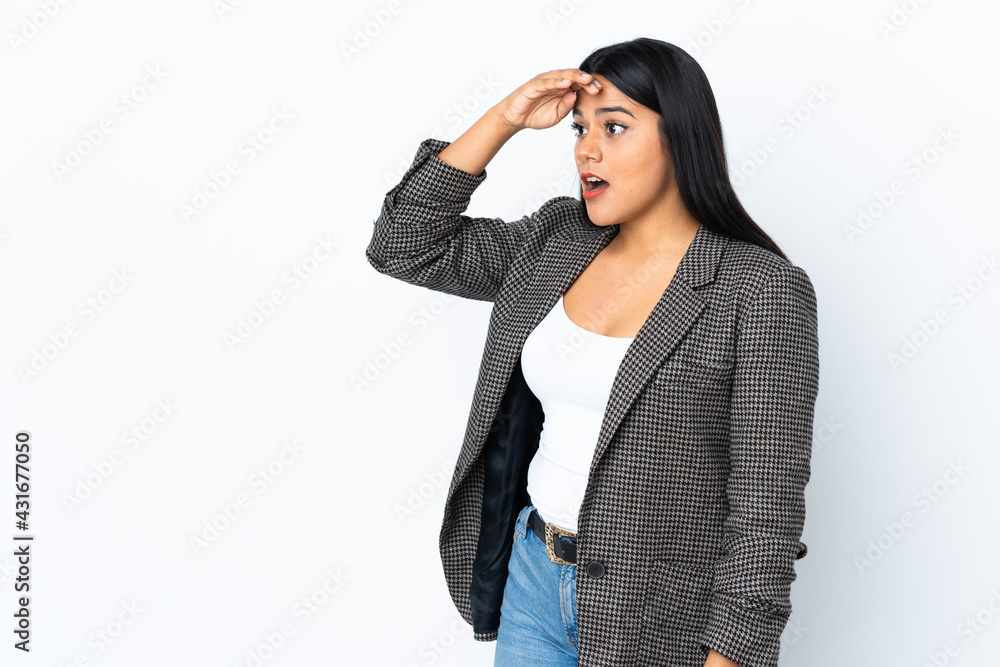 Young latin woman woman isolated on white background with surprise expression while looking side Young latin woman woman isolated on white background with surprise expression while looking side