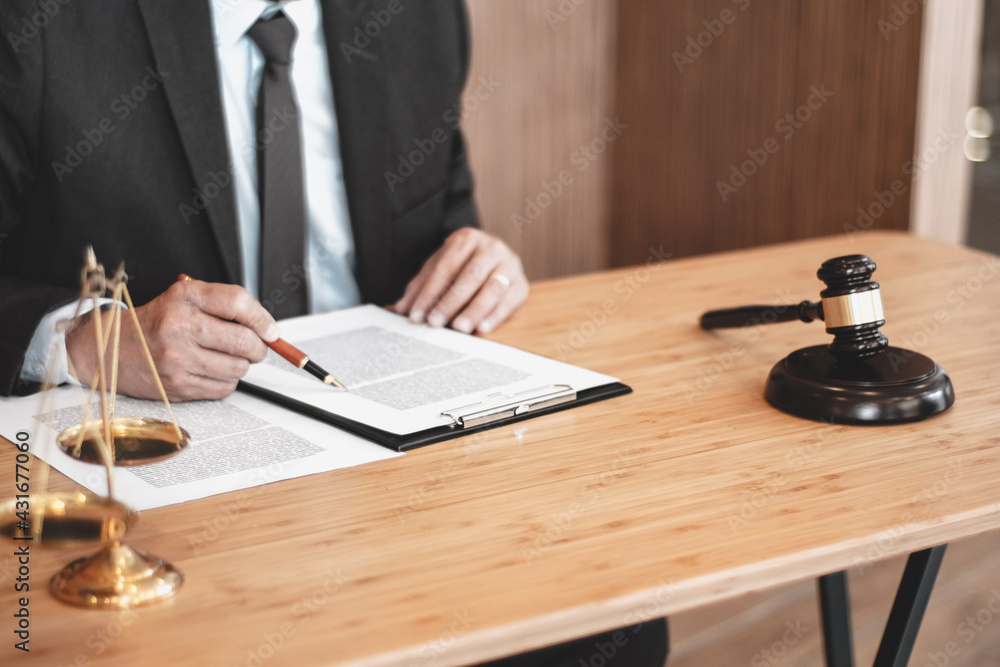 Legal counsel presents to the client a signed contract with gavel and legal law. justice and lawyer concept. Legal counsel presents to the client a signed contract with gavel and legal law. justice and lawyer concept.