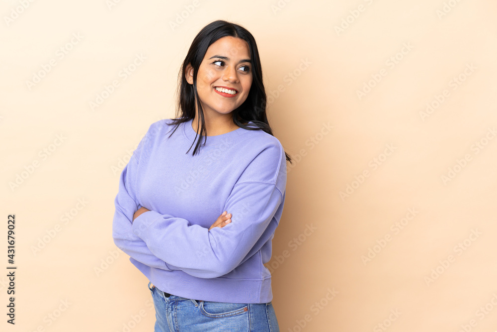 Young latin woman woman over isolated background with arms crossed and  happy Stock-Foto | Adobe Stock