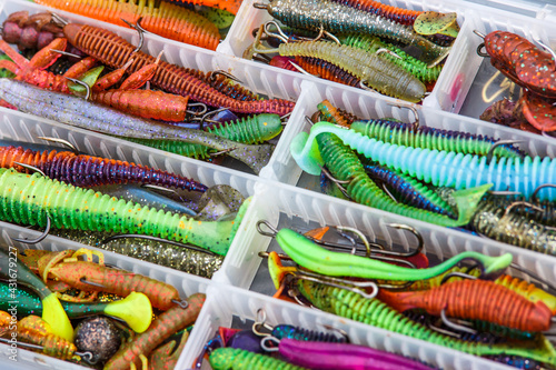 A large fisherman's tackle box fully stocked with lures and gear for fishing.fishing lures and accessories in the box background.