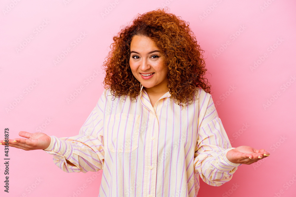 Young latin curvy woman isolated on pink background showing a welcome expression. Young latin curvy woman isolated on pink background showing a welcome expression.