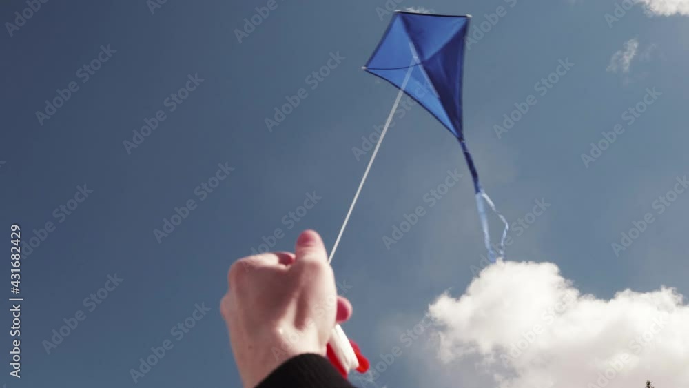 A blue kite soars in the sky. The concept of freedom, summer hobbies ...