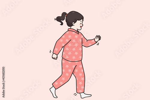 Happy childhood and trendy children clothes concept. Small cute smiling cheerful baby girl in pink warm comfortable jumpsuit barefoot walking over pink background vector illustration 