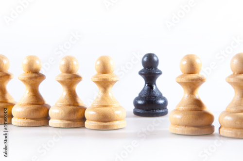 Black and white chess pieces on the white background