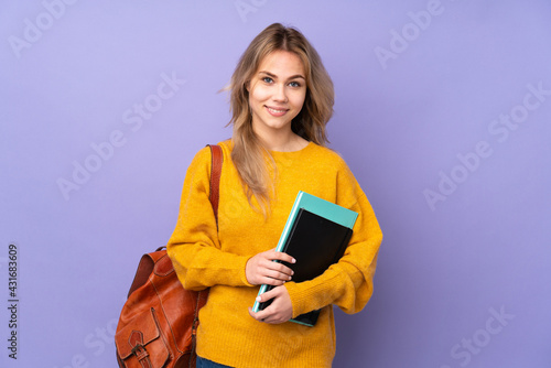 Teenager Russian student girl isolated on purple background keeping the arms crossed in frontal position