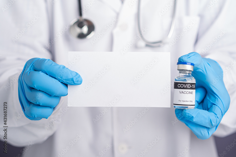 A doctor holding a white paper blank and a COVID-19 vaccine. Vaccine for immunization, and treatment from virus infection. Concept of medical and the fight against the virus A doctor holding a white paper blank and a COVID-19 vaccine. Vaccine for immunization, and treatment from virus infection. Concept of medical and the fight against the virus