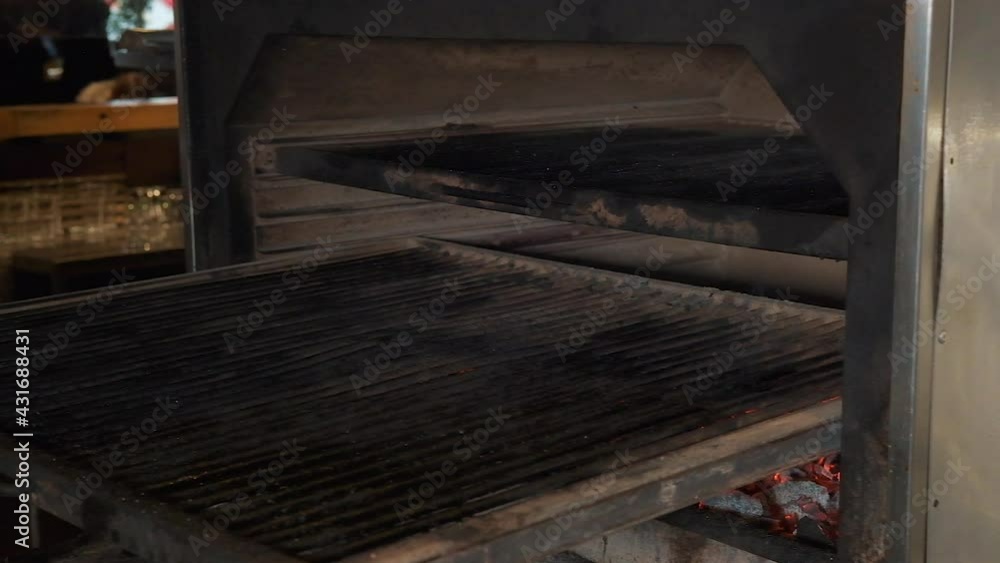 Chef is putting skewers with meat on the grill over charcoal. Meat on skewers. Restaurant complex. Chef is putting skewers with meat on the grill over charcoal. Meat on skewers. Restaurant complex.