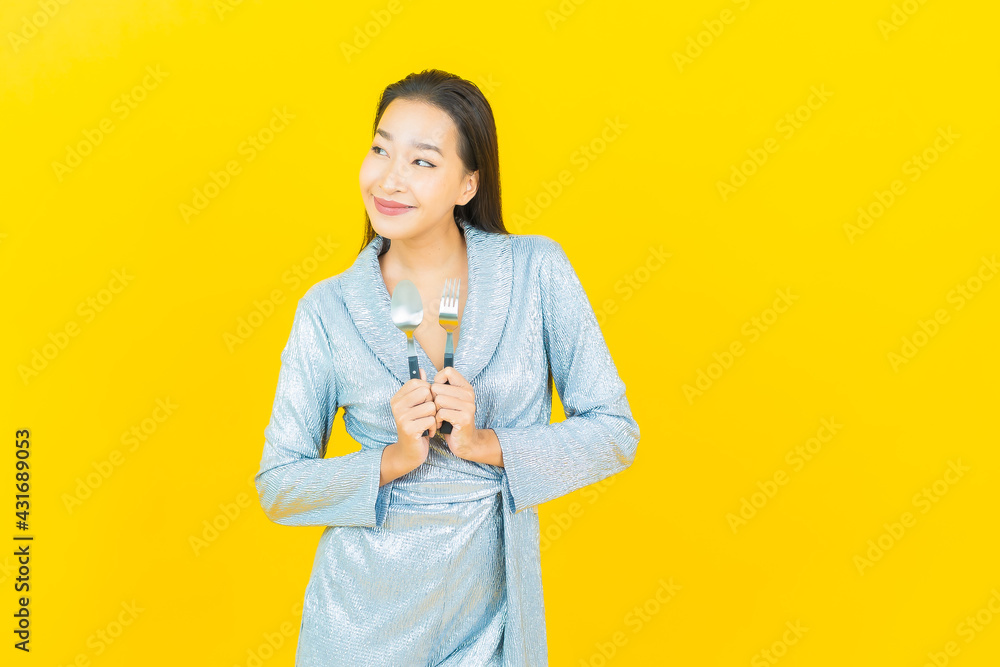 Portrait beautiful young asian woman smile with spoon and fork Portrait beautiful young asian woman smile with spoon and fork