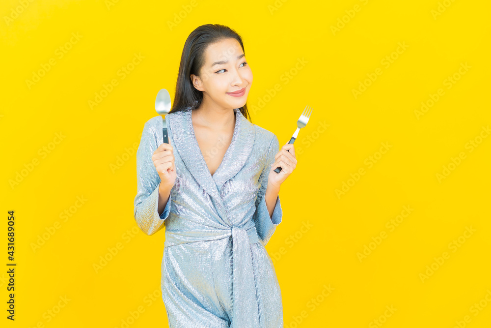 Portrait beautiful young asian woman smile with spoon and fork Portrait beautiful young asian woman smile with spoon and fork