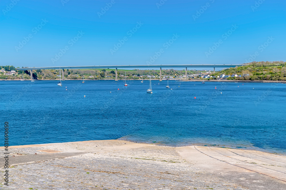 A view towards the Cleddau bridge across the Haven down a slipway at Pembroke Dock, Pembrokeshire, South Wales on a sunny day