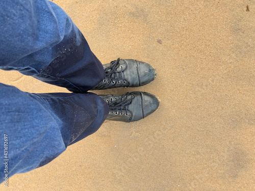 Soaked boots and jeans at the beach