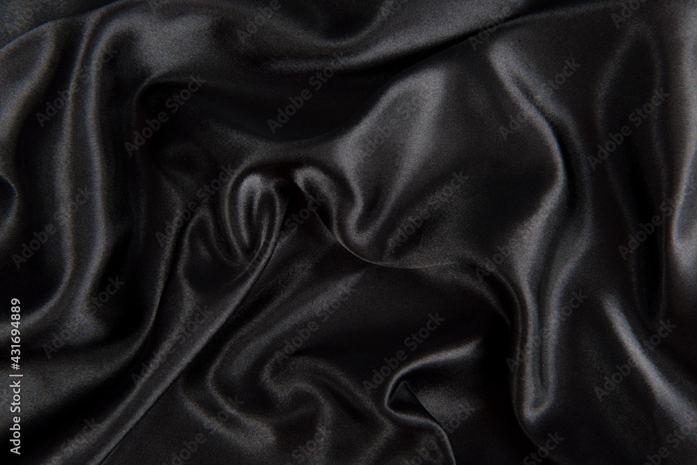 Abstract black silk fabric texture background. Cloth soft wave. Creases of satin Abstract black silk fabric texture background. Cloth soft wave. Creases of satin